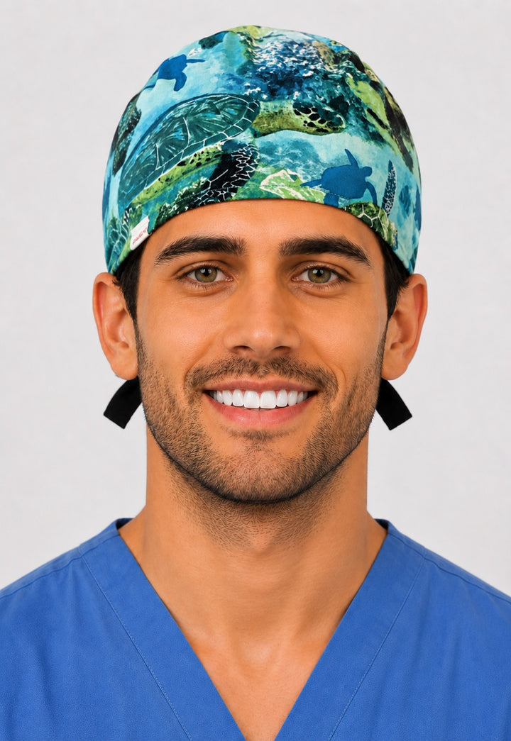 Sea turtle scrub cap front view on a man — tropical underwater ocean marine life print, cotton tie-back surgical cap for nurses