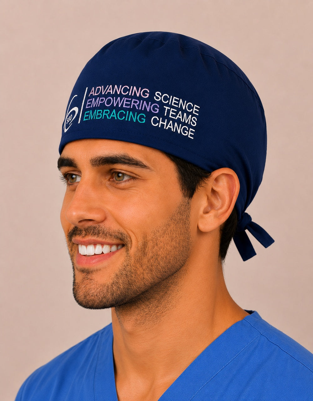Three-quarter view of the navy SGO men's embroidered tie-back surgical hat showing the official SGO logo band
