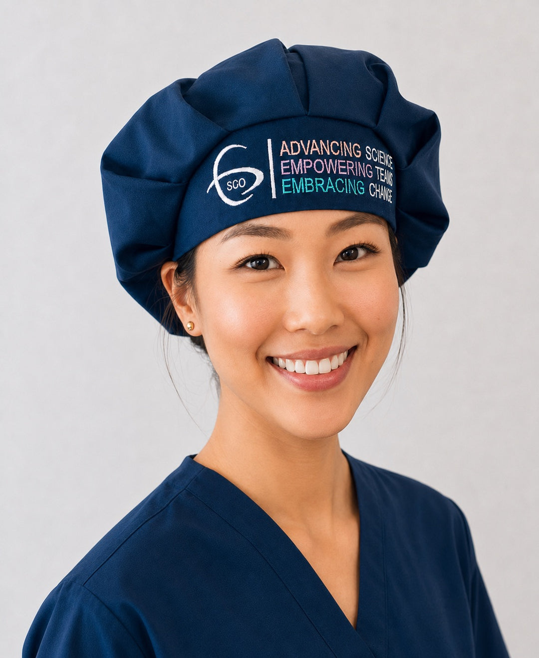 SGO member bouffant surgical hat in navy with premium multicolor Society of Gynecologic Oncology logo embroidery, front angle