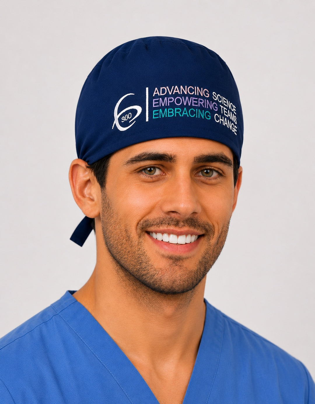 Male healthcare professional wearing the navy SGO official traditional tie-back scrub cap, men&