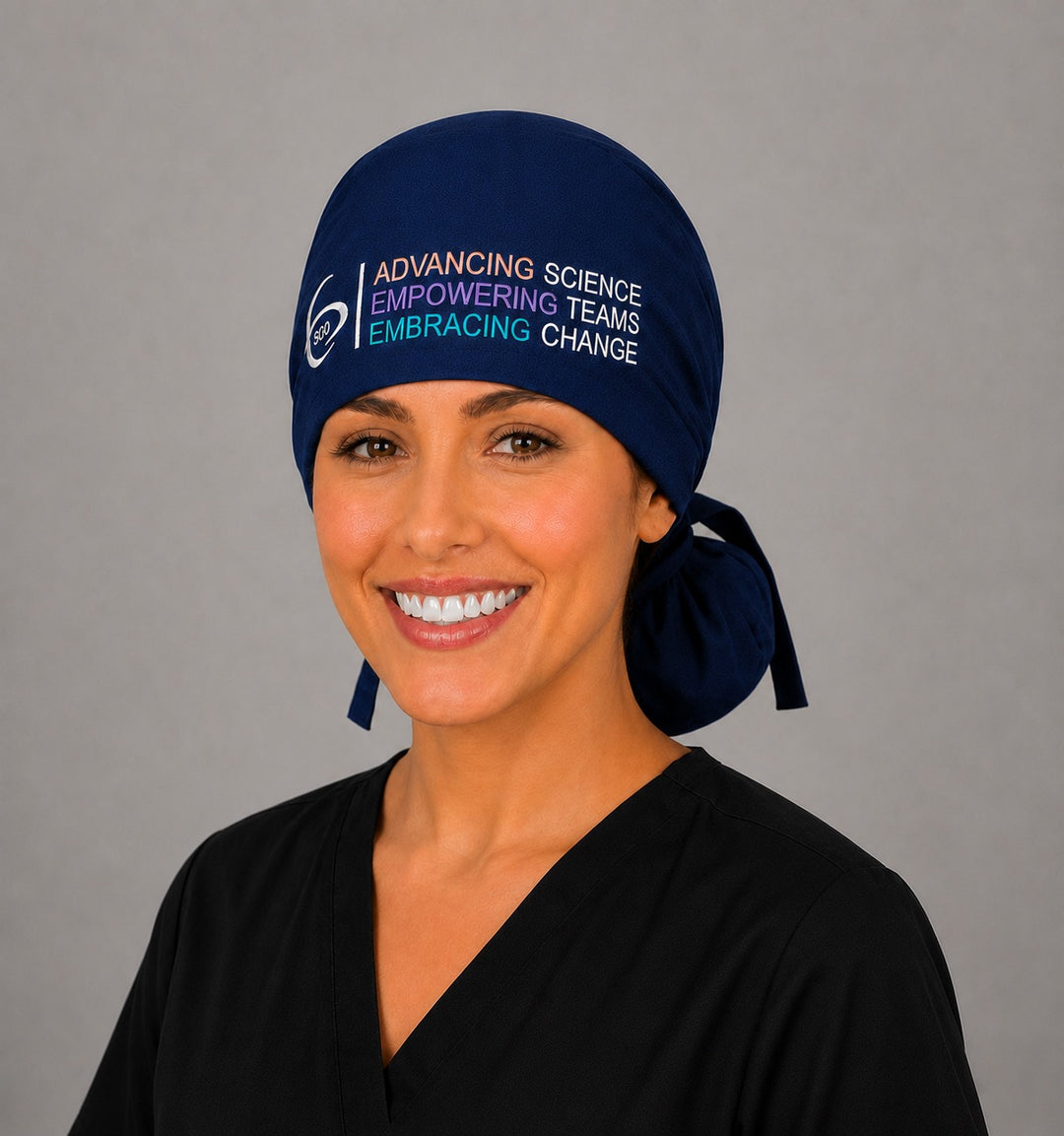 Angled front view of a healthcare professional in the navy SGO official embroidered ponytail scrub cap with the multicolor SGO logo, ideal for bulk team and university logo orders