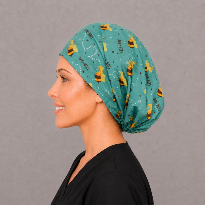 Sleeping baby bee Euro cap for women, left side profile — handmade teal baby-themed surgical cap, USA made