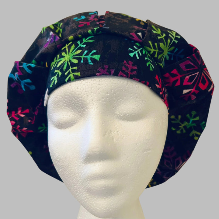 Back view of rainbow snowflake bouffant scrub cap with room for long hair — handmade-in-USA Christmas OR World surgical hat.