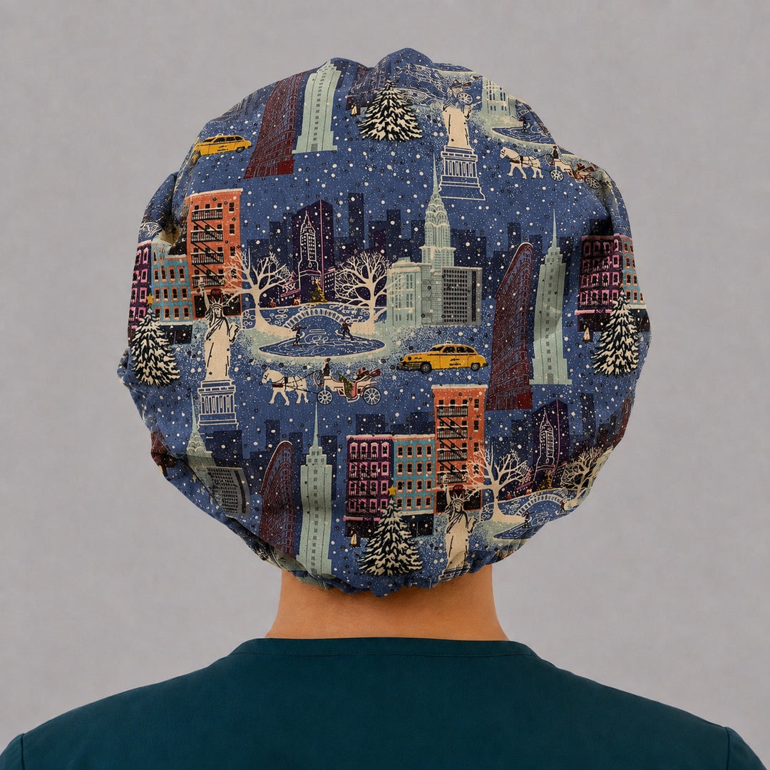 Back view of the snowy NYC bouffant scrub cap — full gathered coverage showing the Christmas city skyline, taxis and evergreens