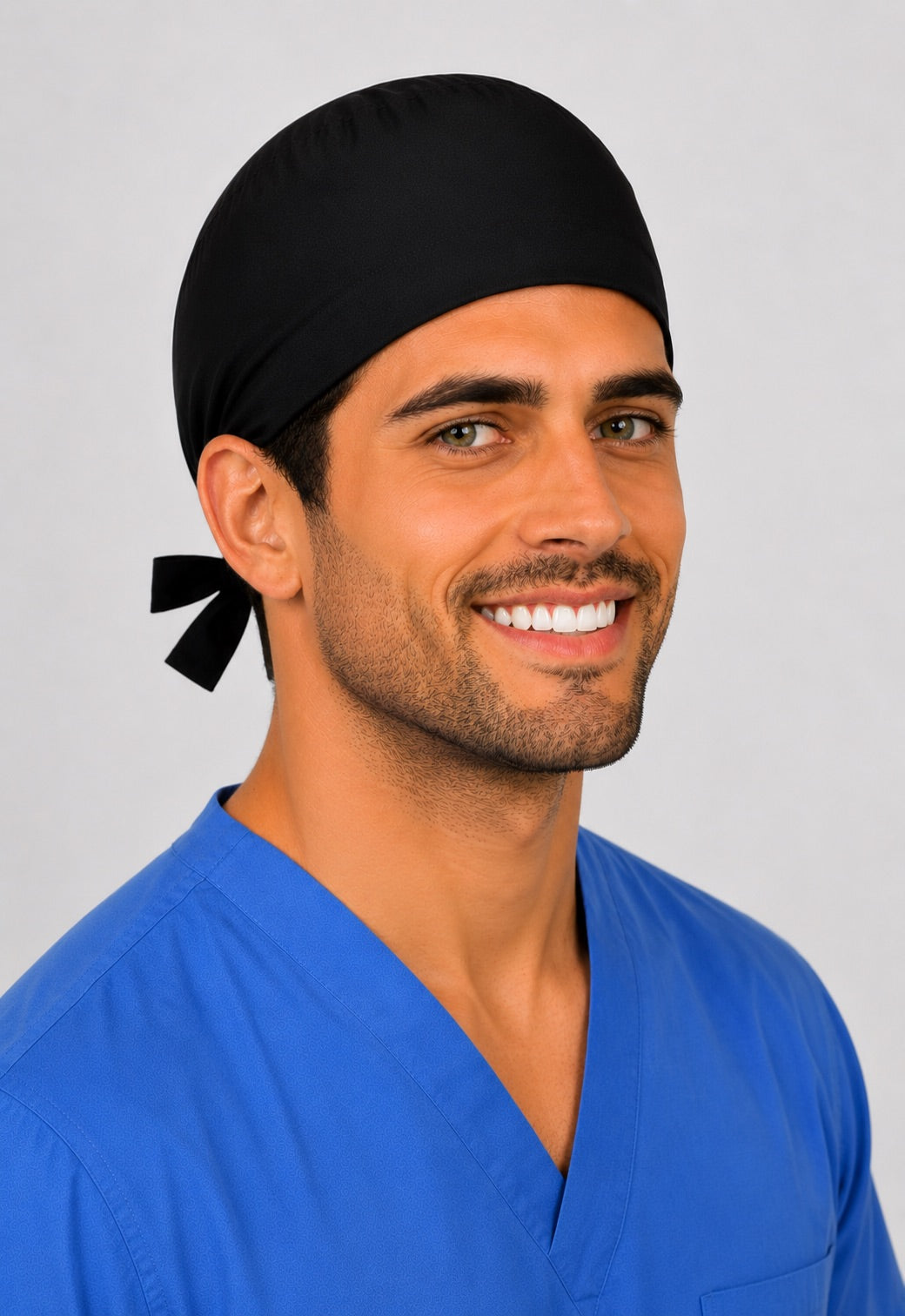 Profile view of solid black tie-back scrub cap with embroidered "Dr. Ellis" name on a male model — handmade-in-USA men&