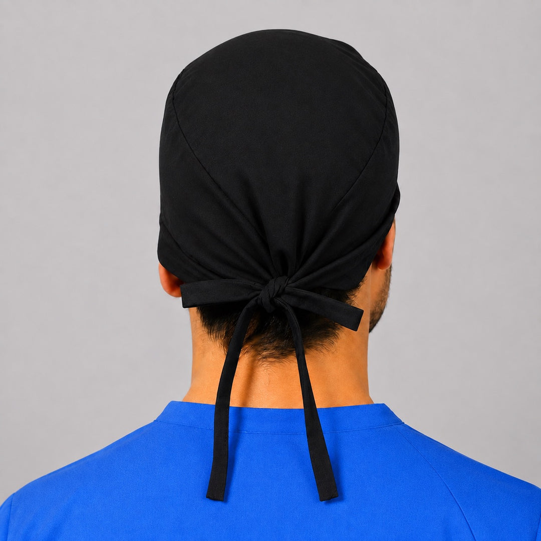 Side view of solid black tie-back scrub cap with embroidered "Dr. Ellis" name on a male model — handmade USA surgical hat for OR nurses, surgeons &amp; techs