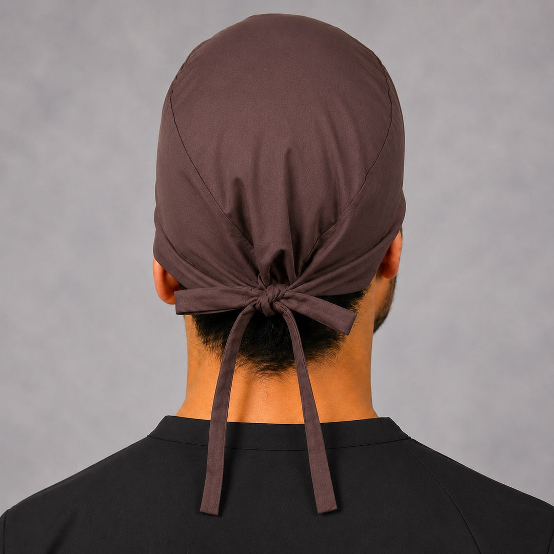 Back view of adjustable tie-back knot on solid brown scrub cap surgical hat for men