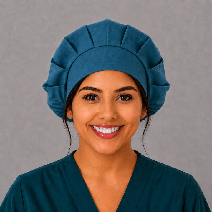 Woman wearing a solid country blue bouffant scrub cap, front view — plain teal-blue adjustable surgical hat for nurses