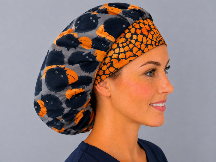 Side view of the spooky cat and pumpkin bouffant surgical hat — orange spiderweb contrast band, roomy breathable cotton cap for nurses