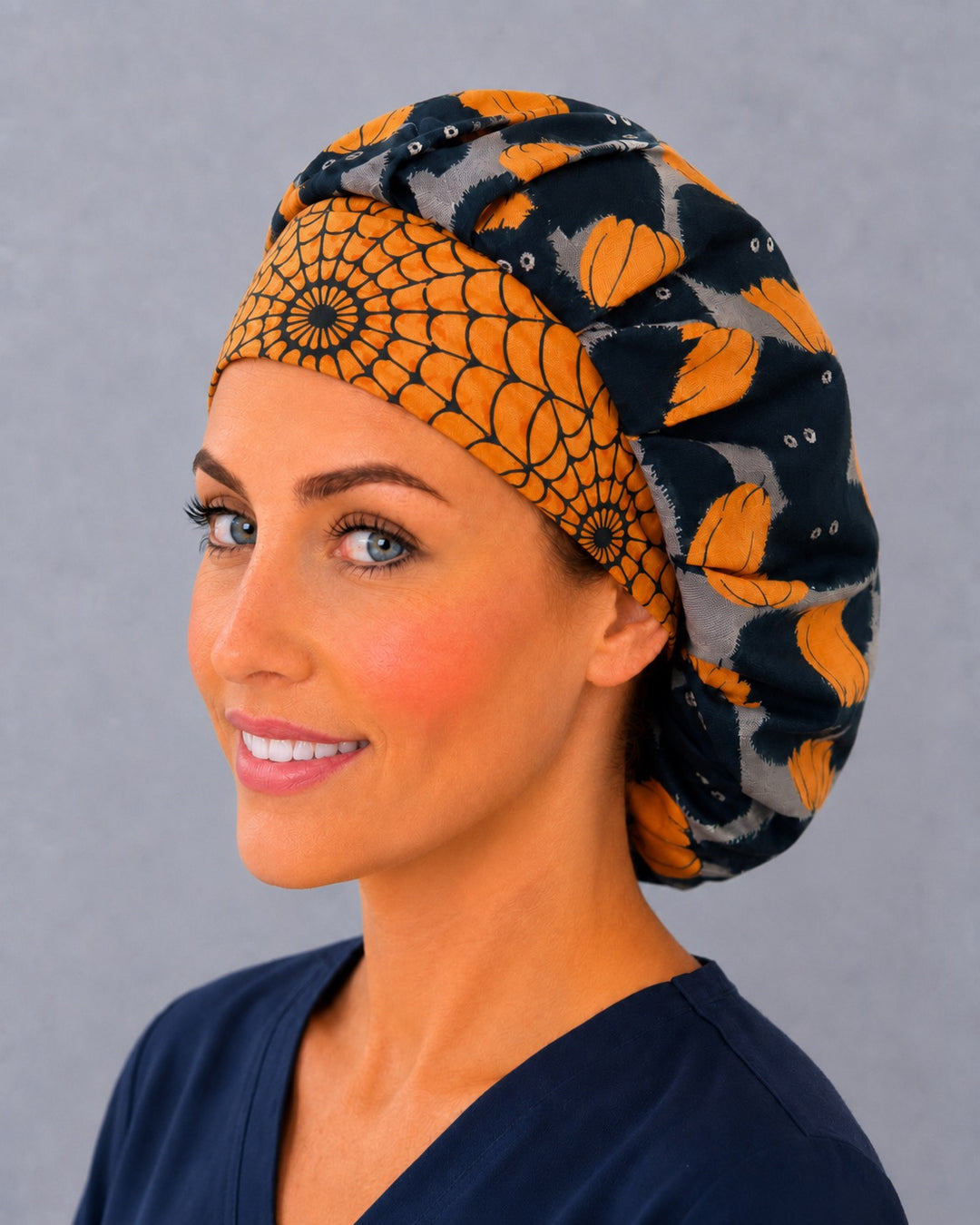Spooky season bouffant surgical cap for women, three-quarter view — cat and pumpkin print bouffant scrub hat, breathable cotton