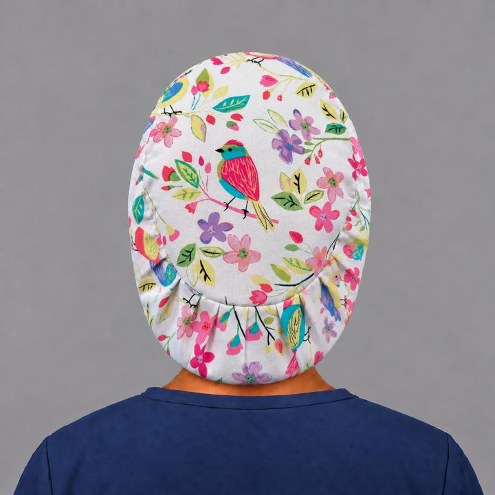 Back view of the spring bird Euro scrub cap — elastic gathered back showing songbirds and flowers across the crown