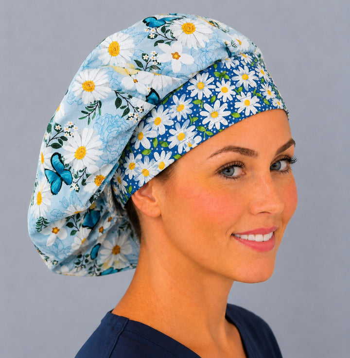 Profile view of the spring floral bouffant surgical hat — blue butterfly and daisy print, a cheerful gift for nurses and surgical techs