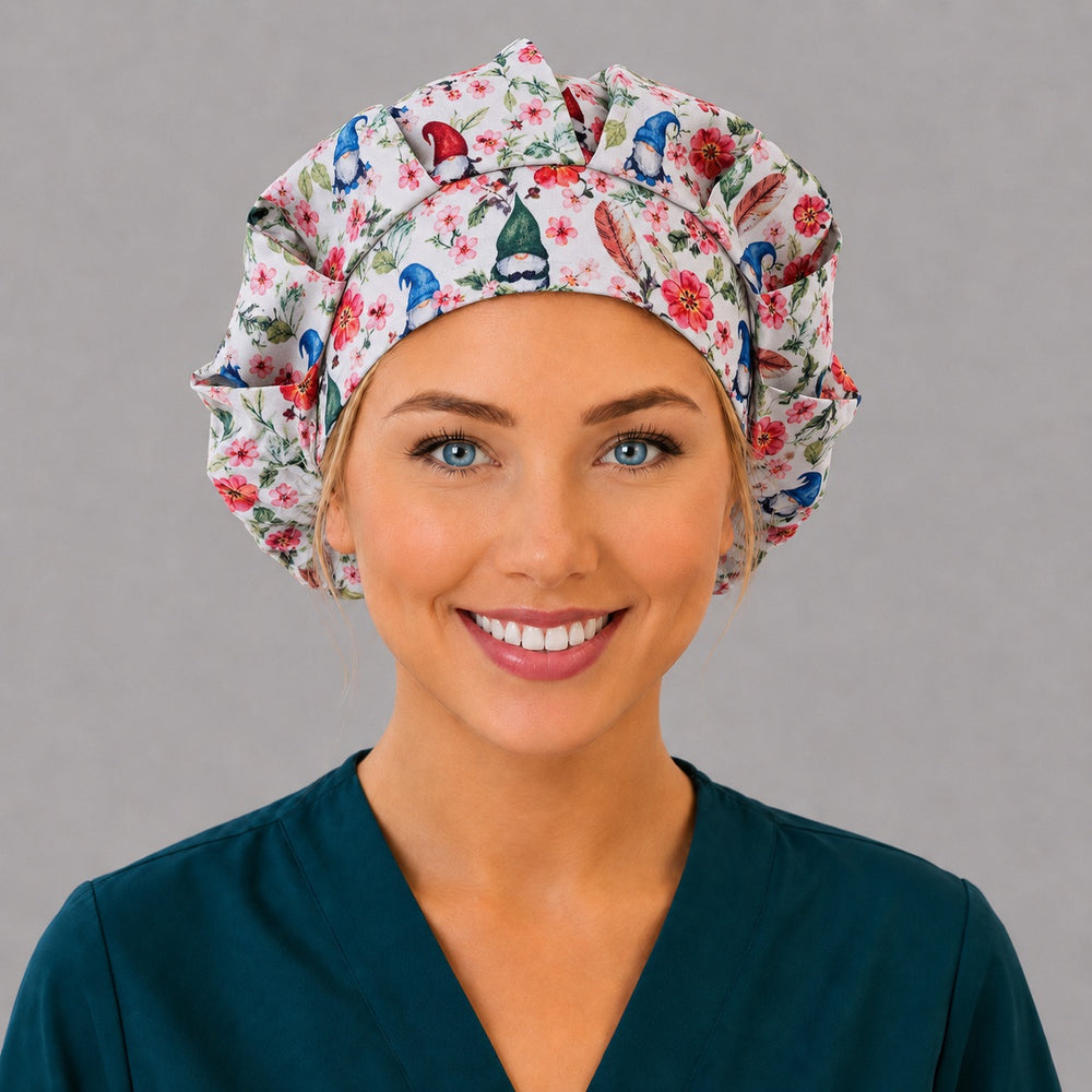 Woman wearing a spring gnome floral bouffant scrub cap, front view — garden gnomes and pink blossoms on white, adjustable women's surgical hat