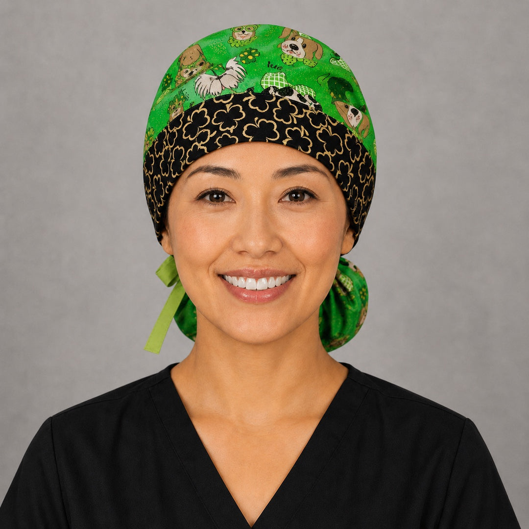 Woman wearing St. Patrick's dogs ponytail scrub cap, front view smiling with dogs in leprechaun hats and clovers on green with black clover band and lime green ribbon tie
