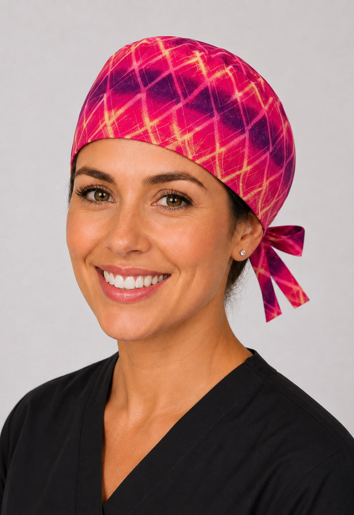 Left view of Starlight pink and purple tie dye starburst scrub cap for short hair on OR nurse, handmade unisex tie-back surgical hat