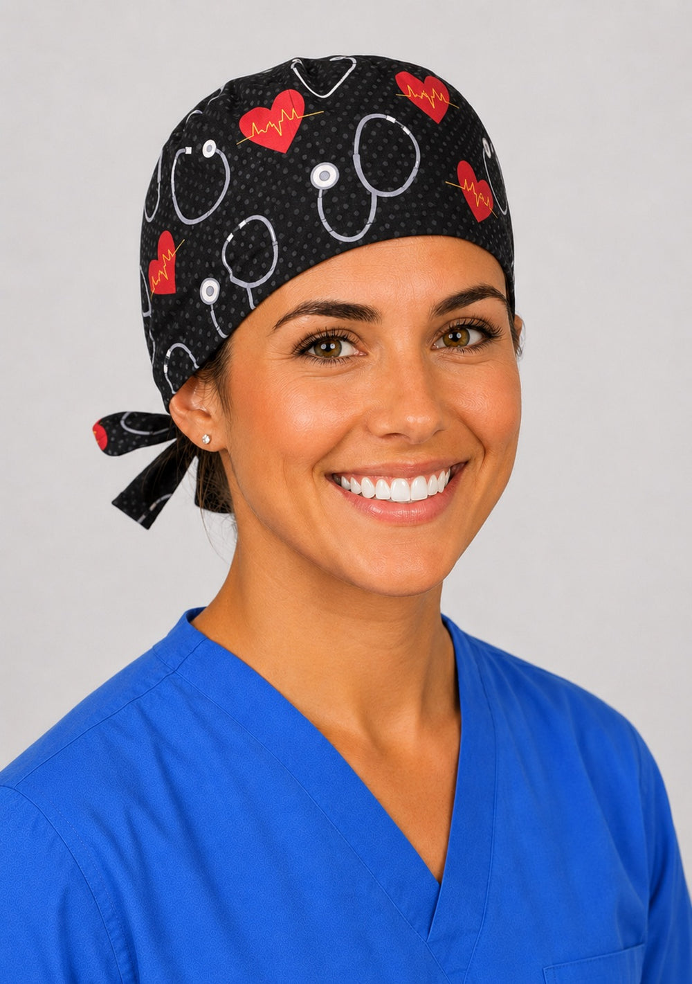 Three-quarter view of black stethoscope and red heart unisex adjustable surgical hat for cardiology, ICU and ER nurses