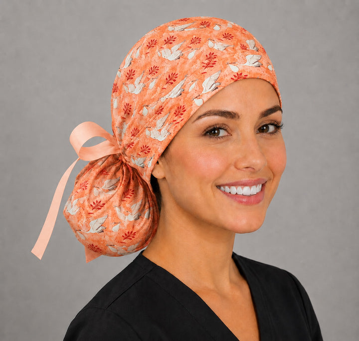 Stork ponytail scrub cap for L&amp;D and GYN nurses, coral crane print labor and delivery surgical hat for women with long hair, back pouch and peach ribbon bow, handmade USA, OR World