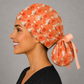 Side view of stork ponytail scrub cap showing back pouch for long hair, coral crane print GYN and OB surgical hat, handmade USA, OR World