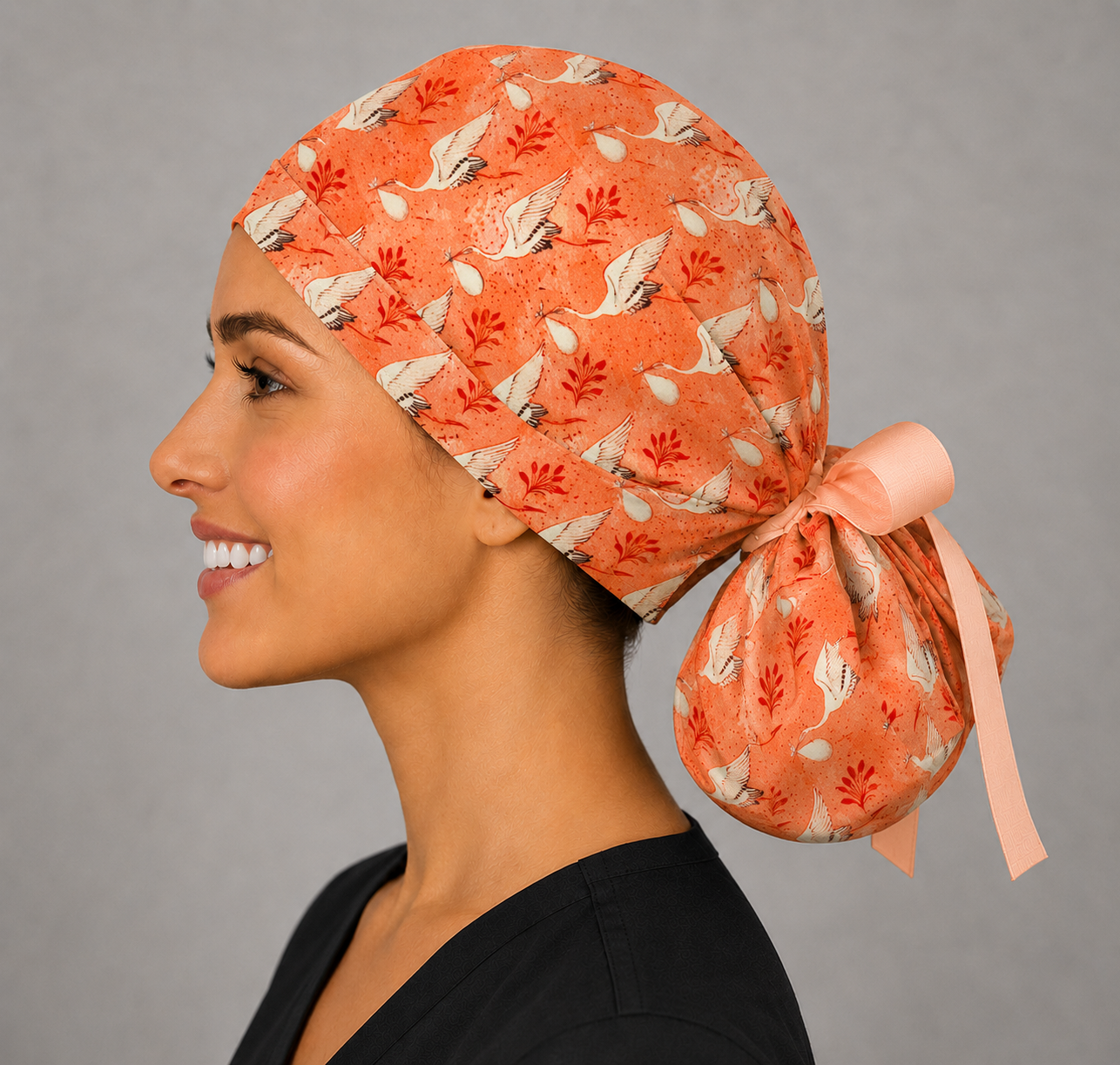 Side view of stork ponytail scrub cap showing back pouch for long hair, coral crane print GYN and OB surgical hat, handmade USA, OR World
