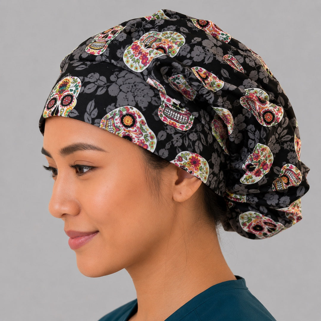 Sugar skull bouffant scrub cap left side profile showing colorful floral sugar skulls on black tonal-floral, women&