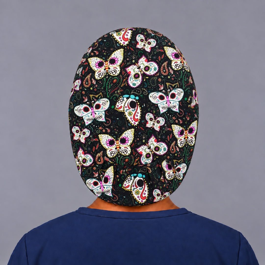 Back view of the sugar skull butterfly Euro scrub cap — elastic gathered back showing painted skull butterflies across the black crown