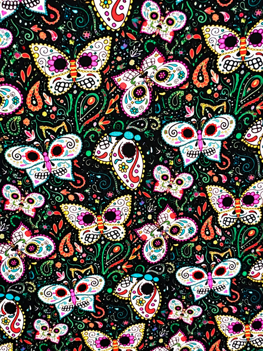 Fabric close-up for the sugar skull butterfly ponytail cap, skull winged mariposas with coral paisley and green vines on black premium cotton