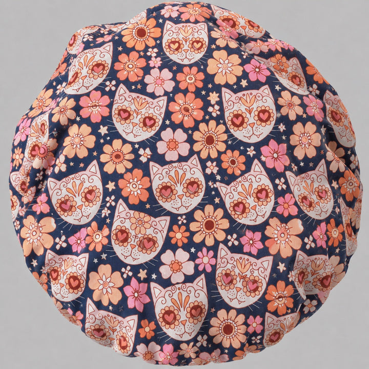 Back view of the sugar skull cat bouffant scrub cap — full gathered fit showing calavera cats and floral print across the navy crown
