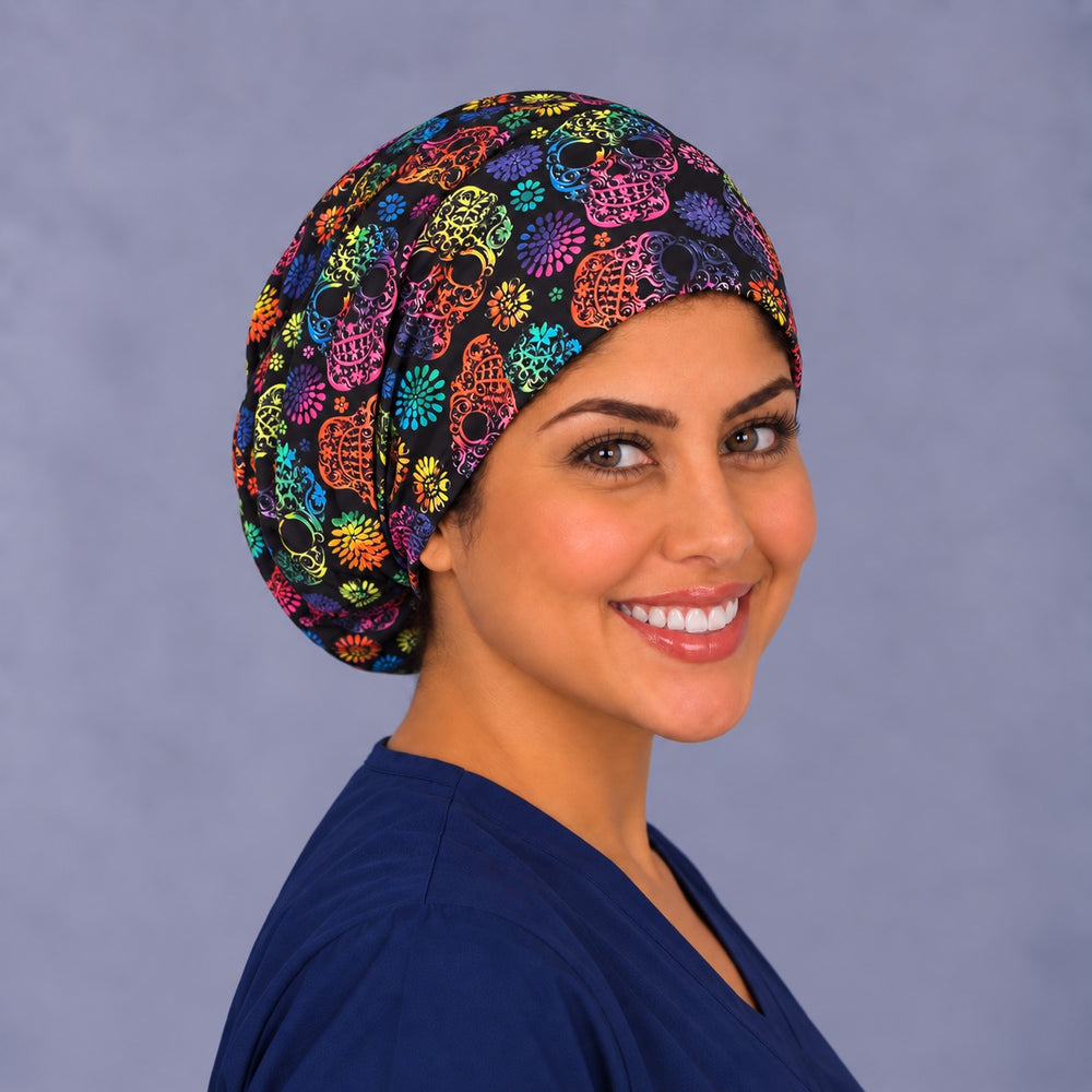 Rainbow Sugar Skull Euro scrub cap, right angled smiling view — colorful skull print on black, adjustable surgical hat