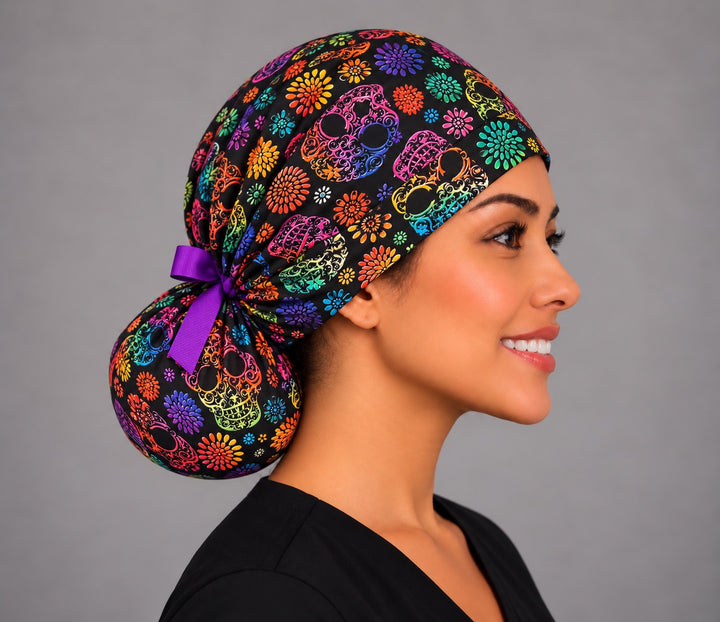 Right profile of the sugar skull ponytail surgical hat with purple grosgrain bow, for OR nurses and surgical techs