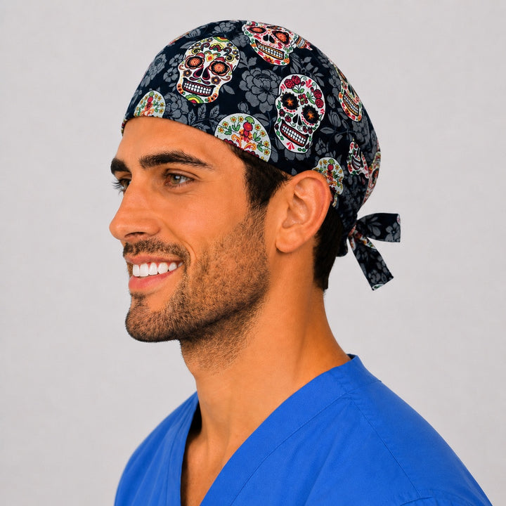 Sugar skull scrub cap front view on a man — Day of the Dead floral skulls on black, cotton tie-back surgical cap for nurses