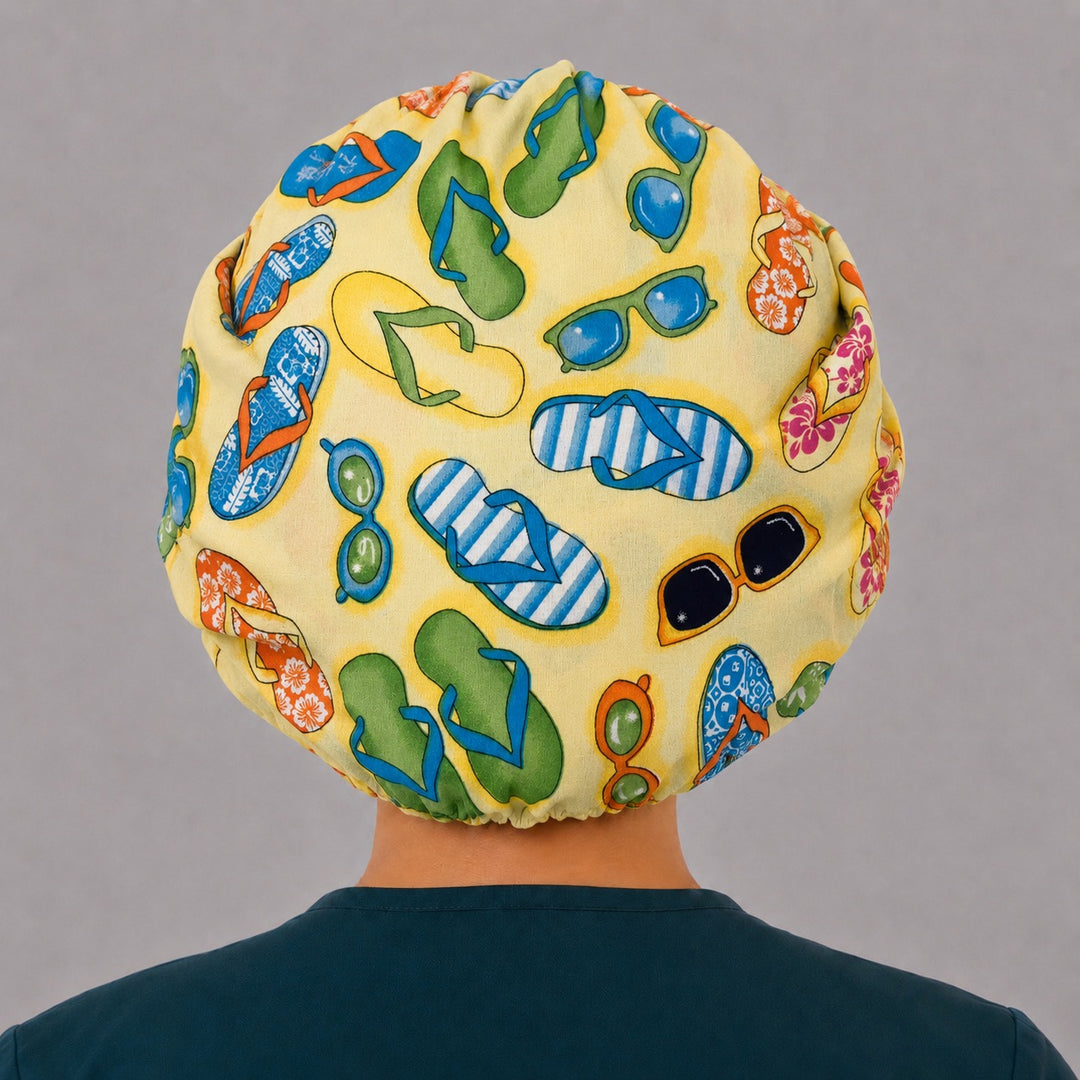 Summer beach bouffant cap for women, right angled smiling view — handmade flip flop print surgical cap, USA made