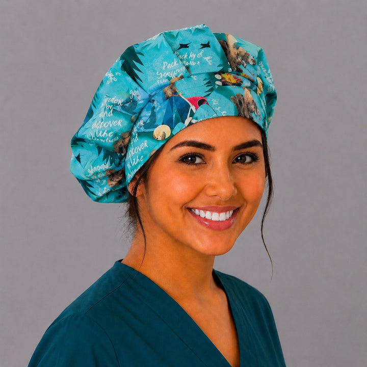 Summer camping bouffant scrub cap right three-quarter angle on smiling model showing teal camping print with campers, tents and marshmallow-roasting critters, OR World nurse hat