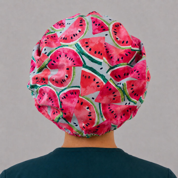Summer watermelon bouffant scrub cap on a smiling nurse, front view — bright fruit print bouffant hat for OR and surgical teams