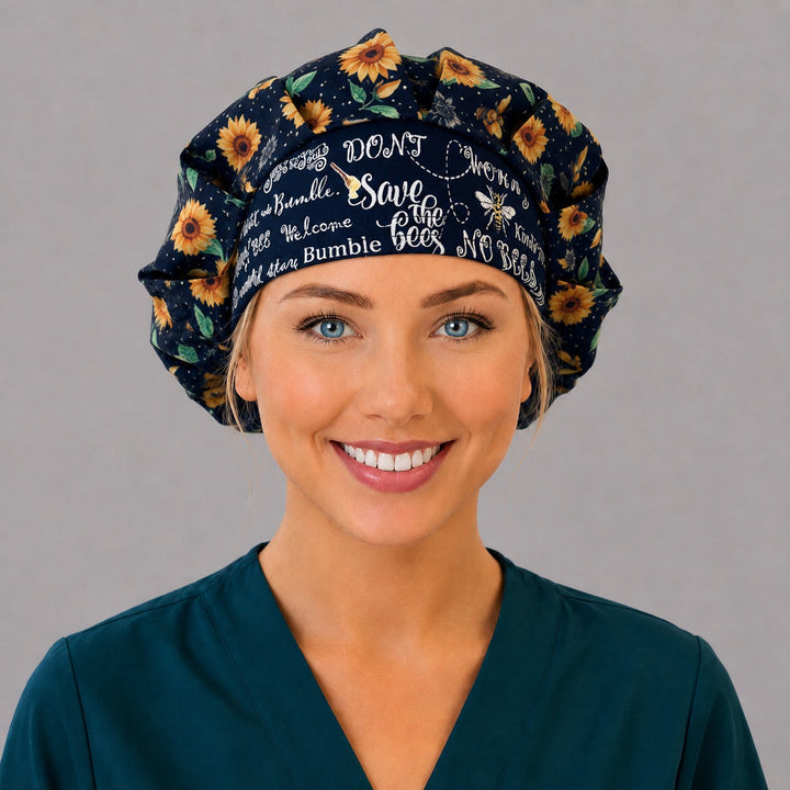 Woman wearing a sunflower bee bouffant scrub cap, front view — black sunflower print with Save the Bees lettered band, adjustable women&