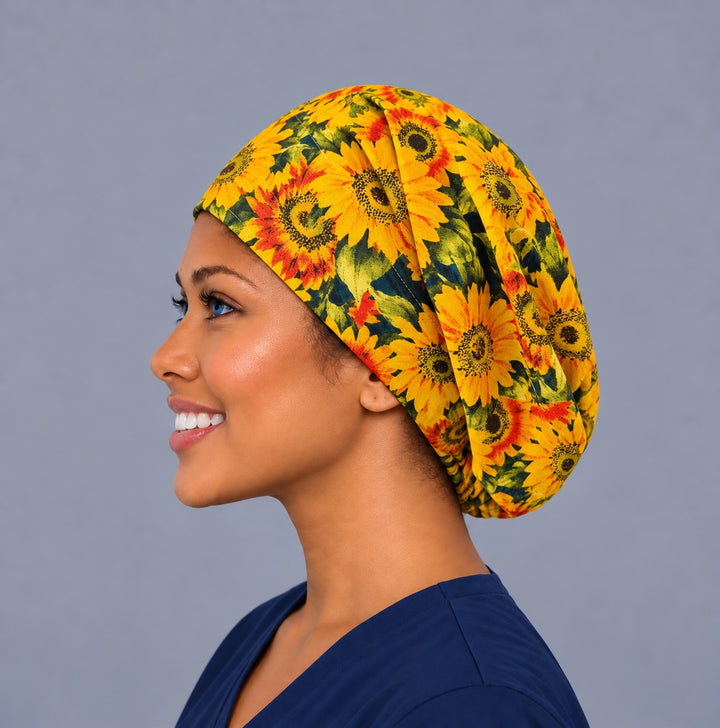 Woman wearing a sunflower Euro scrub cap, front view — golden sunflowers and green leaves, adjustable fall surgical hat for nurses