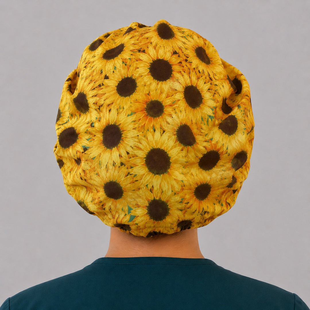 Sunflower bouffant scrub cap for women, front view, golden sunflowers with speckled yellow front band, handmade fall floral surgical hat by OR World