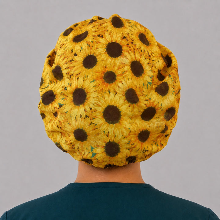 Sunflower bouffant scrub cap for women, front view, golden sunflowers with speckled yellow front band, handmade fall floral surgical hat by OR World