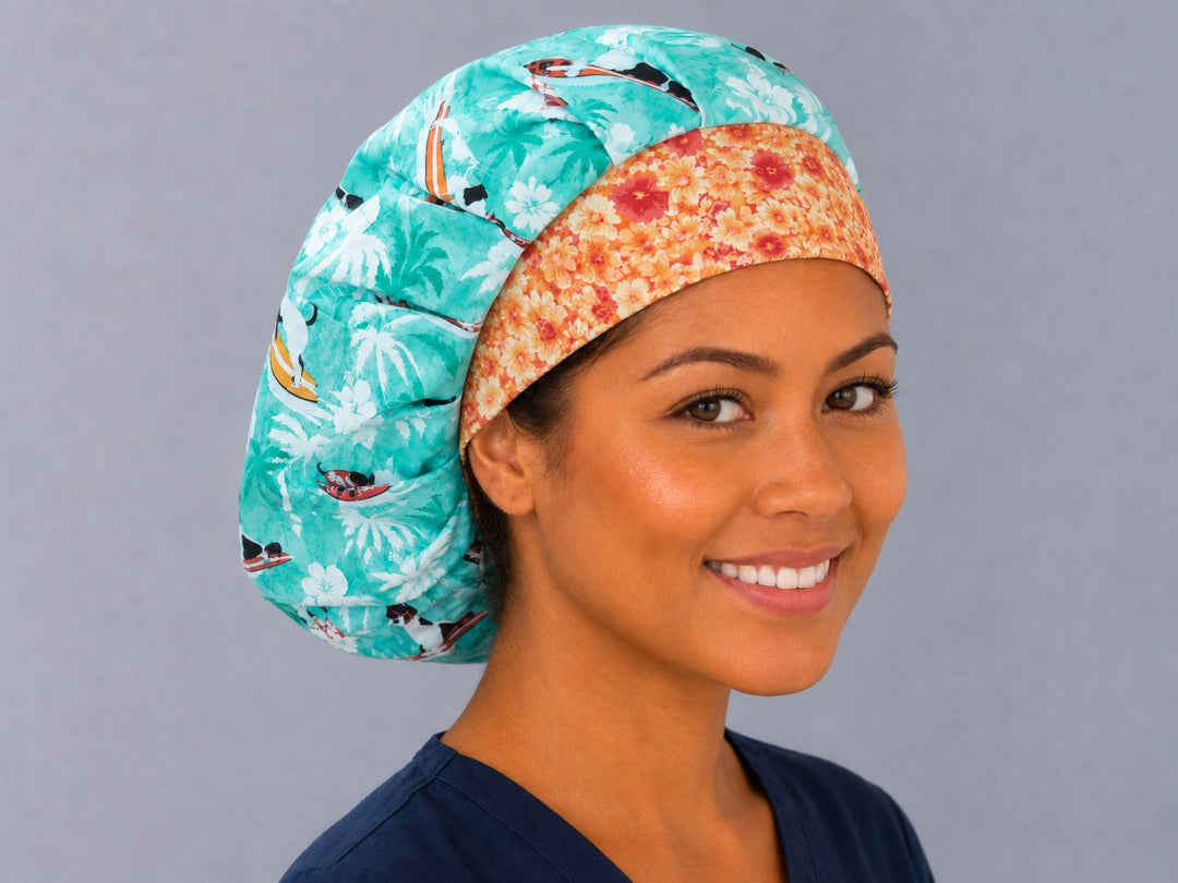 Side view of the surfing dogs bouffant surgical hat — tropical palm and hibiscus print with orange floral contrast band, roomy cotton cap