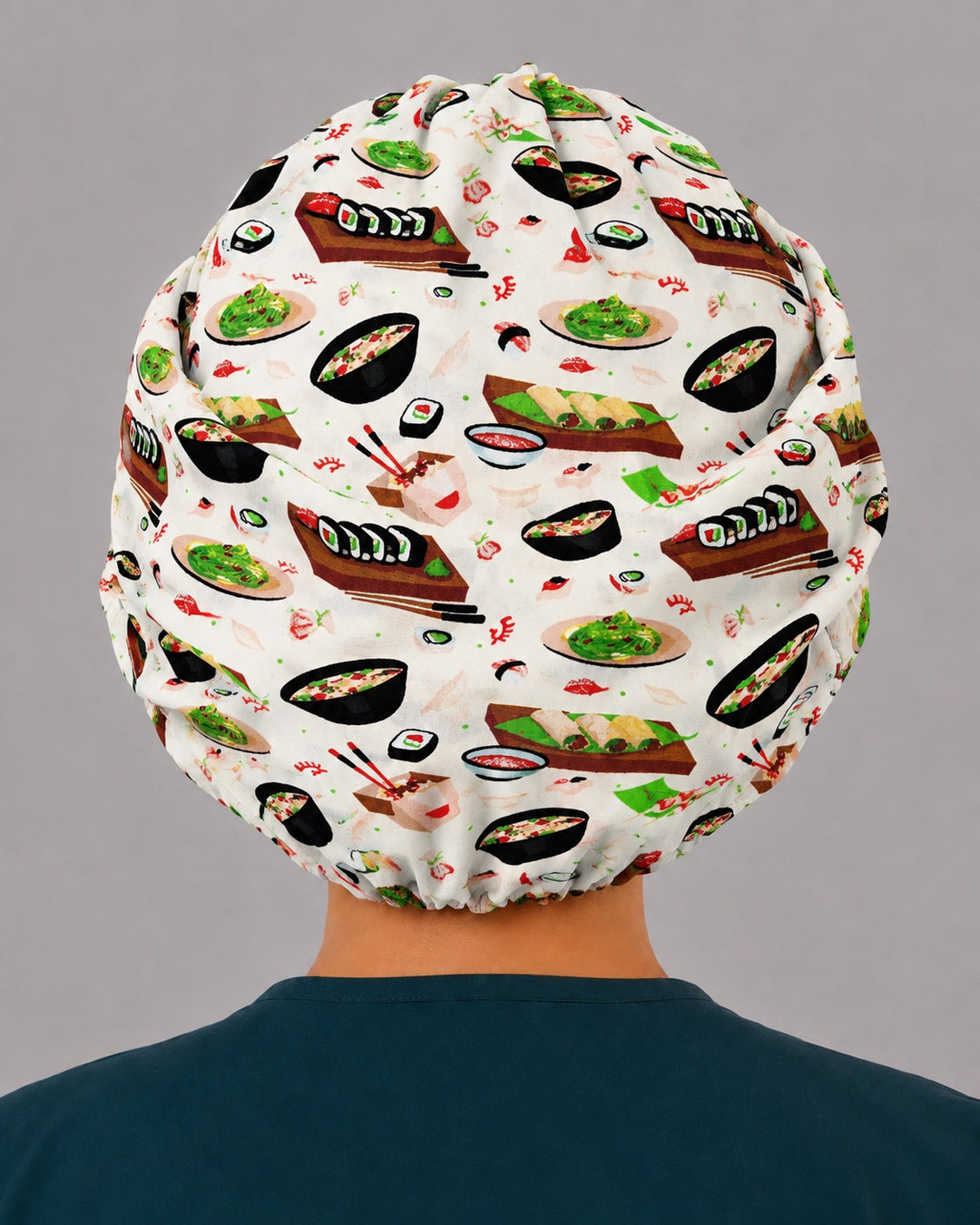 Back view of the sushi bouffant scrub cap — full gathered coverage showing maki rolls, sashimi and ramen bowls across the crown