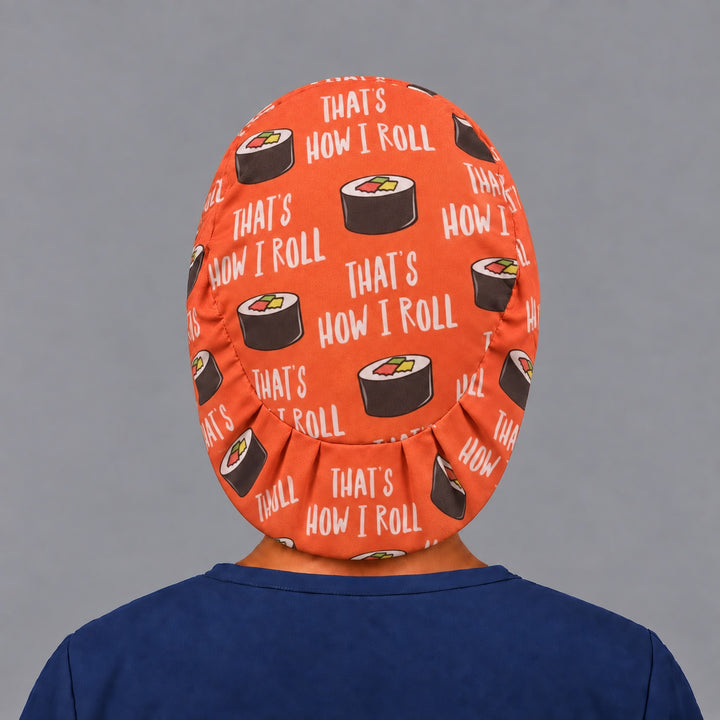Back view of the sushi Euro scrub cap — elastic gathered back showing maki rolls across the orange crown