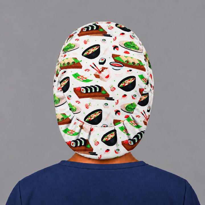 Back view of the Sushi Night Euro scrub cap — elastic gathered back showing sushi boards and bowls across the cream crown