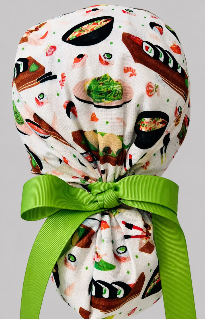 Sushi ponytail scrub cap back view close-up showing gathered pouch full of sushi rolls, ramen bowls, edamame and lime green ribbon bow
