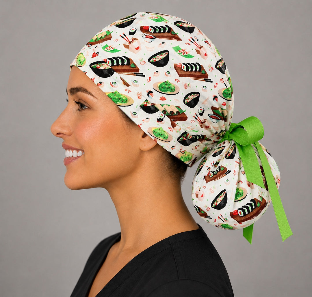 Sushi ponytail surgical cap left side profile showing gathered ponytail pouch of sushi rolls and ramen with lime green ribbon tie