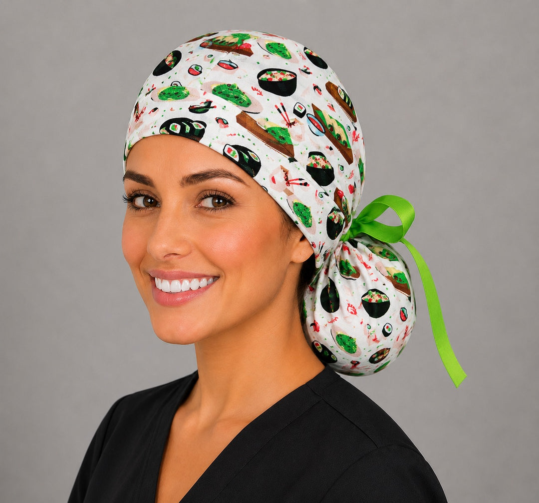 Sushi ponytail nurse cap right three-quarter angle on smiling model showing sushi rolls, edamame, dumplings and lime green grosgrain ribbon bow