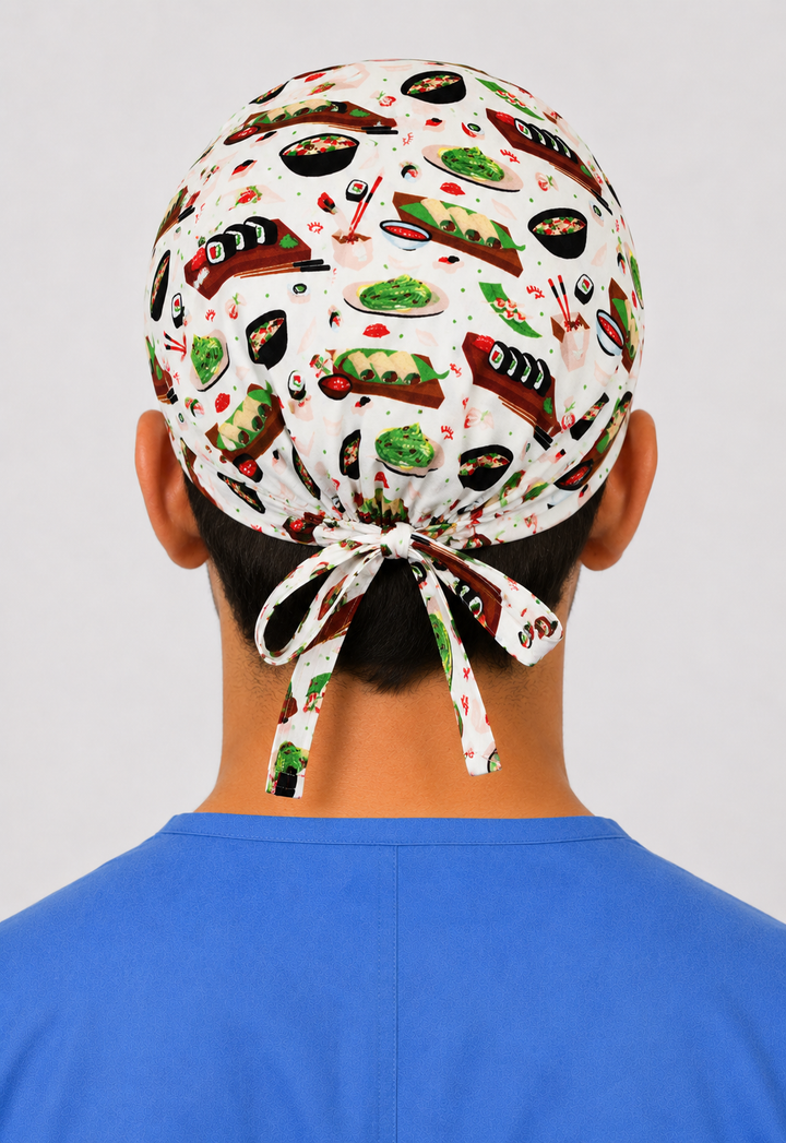 Man wearing a sushi food-print tie-back scrub cap with sushi rolls, edamame &amp; ramen, front view — handmade-in-USA men&