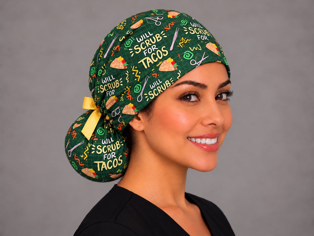 Three-quarter angle of a taco nurse ponytail cap, with a short yellow bow tied above the pouch and tacos across the gathered crown