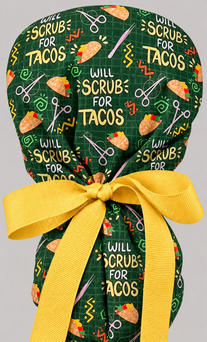 Back view of the taco ponytail scrub cap, showing the gathered crown and long golden yellow grosgrain ribbon tails tied in a wide bow