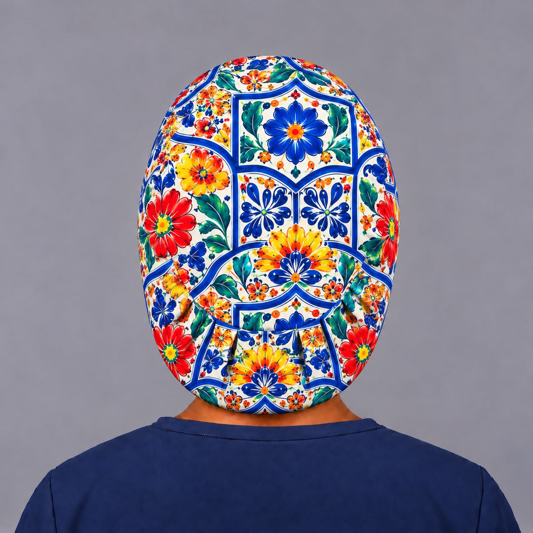 Back view of a Talavera Euro scrub cap with full back coverage and the elastic gather at the nape, centered on a cobalt and yellow tile medallion