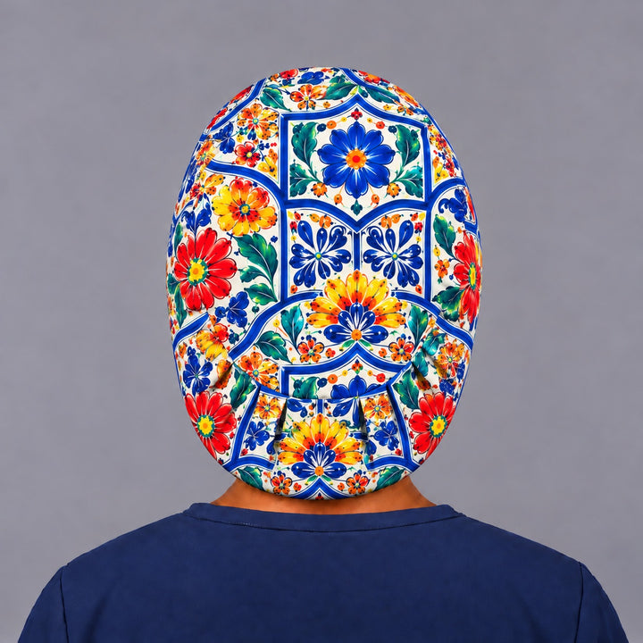 Back view of a Talavera Euro scrub cap with full back coverage and the elastic gather at the nape, centered on a cobalt and yellow tile medallion