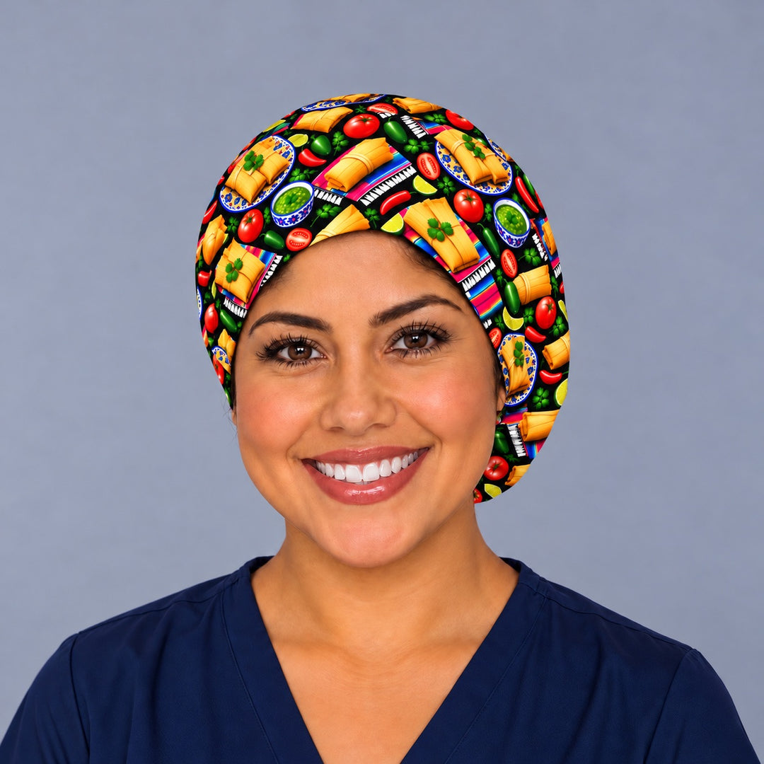 Smiling Latina nurse in navy scrubs wearing a Mexican tamale euro scrub cap, front view with corn husk tamales and cilantro framing the forehead